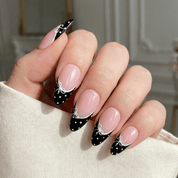 Coquette Bow press-on nails worn on hand – almond shape by Handora