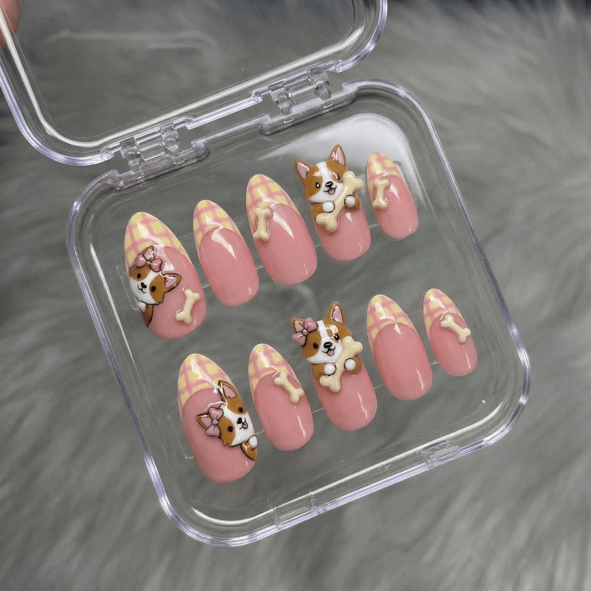 Corgi Bone press-on nails worn on hand – almond shape by Handora