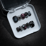 Cosmic Flutter press-on nails worn on hand – almond shape by Handora
