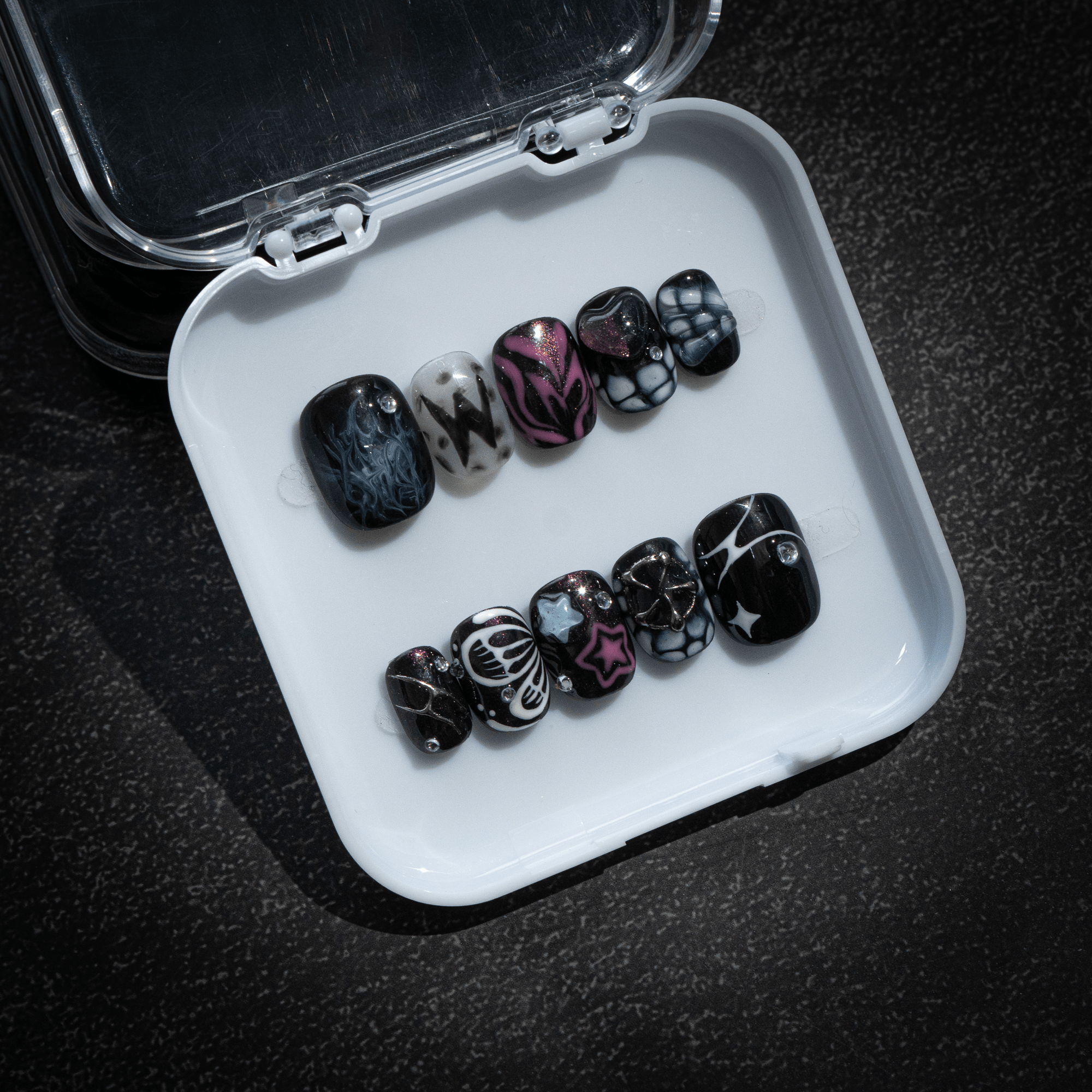 Cosmic Flutter press-on nails worn on hand – almond shape by Handora