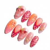 Cosmopolitan press-on nails worn on hand – almond shape by Handora