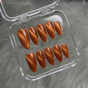 Crimson Aura press-on nails worn on hand – almond shape by Handora