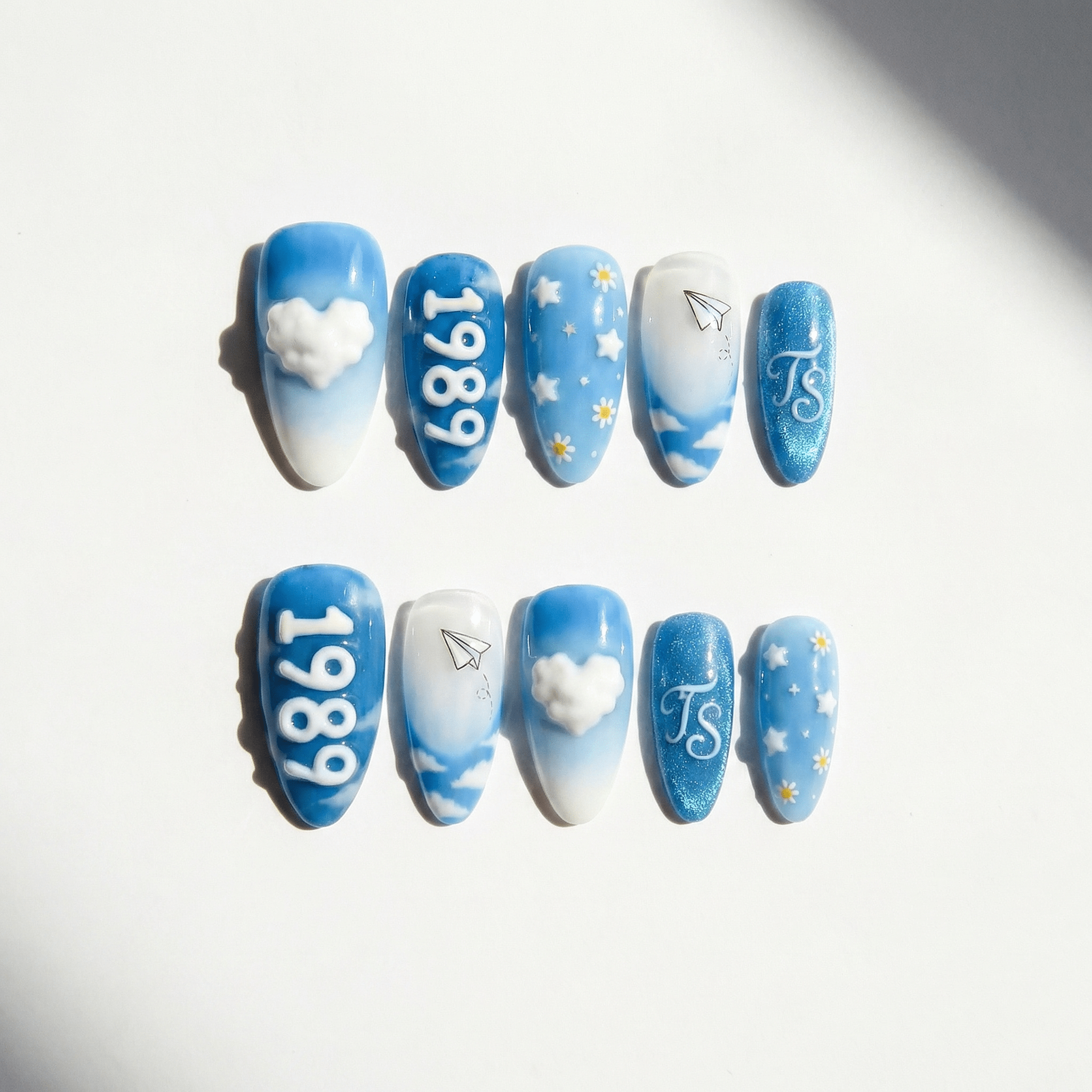 Crystal Skies press-on nails worn on hand – almond shape by Handora