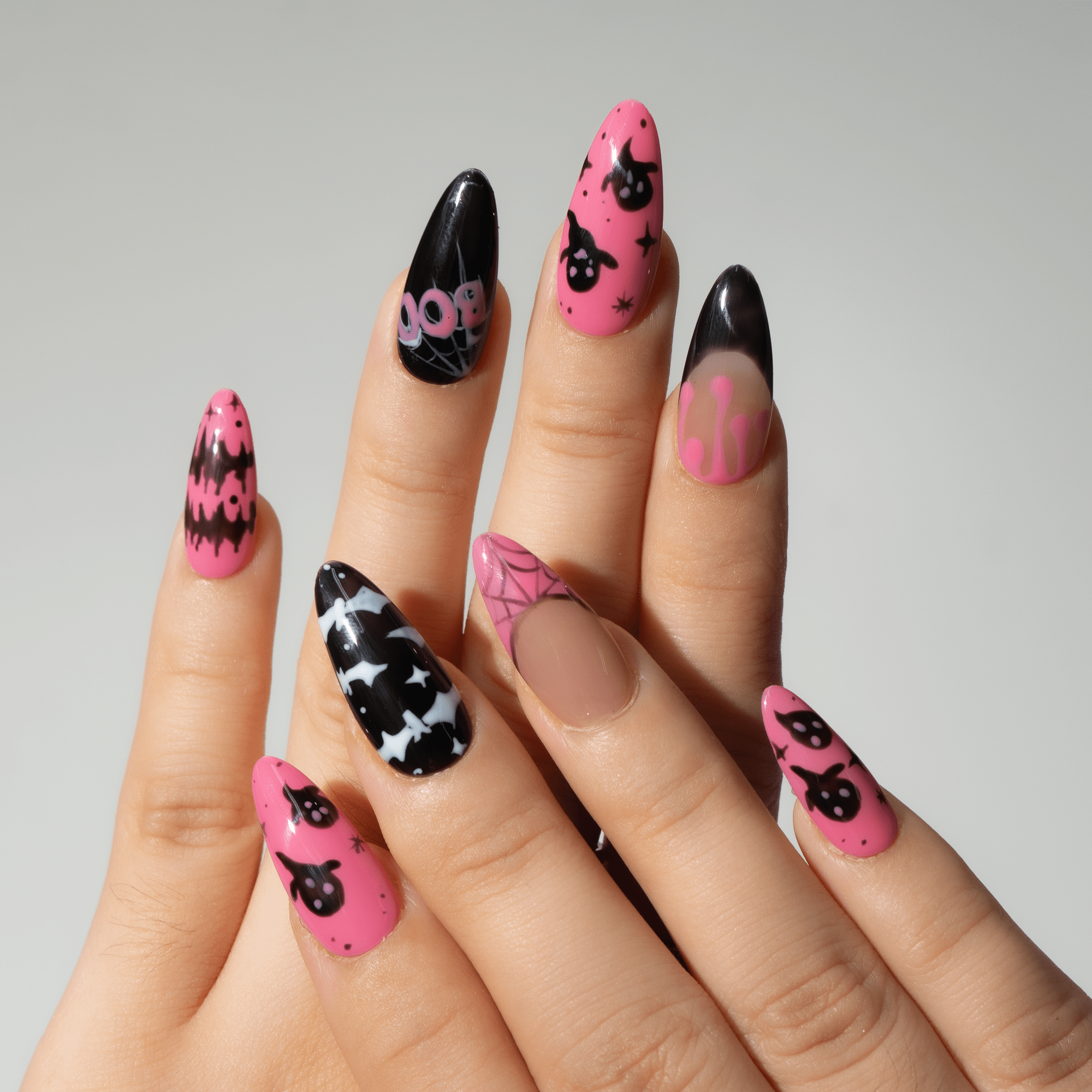 Cute Boo press-on nails worn on hand – almond shape by Handora