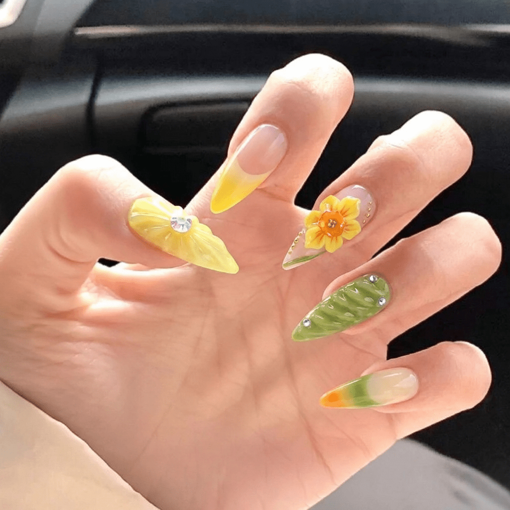 Daffodil Bloom press-on nails worn on hand – stiletto shape by Handora