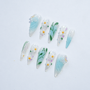 Daisy Garden press-on nails worn on hand – almond shape by Handora