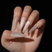 Dawnveil press-on nails worn on hand – almond shape by Handora