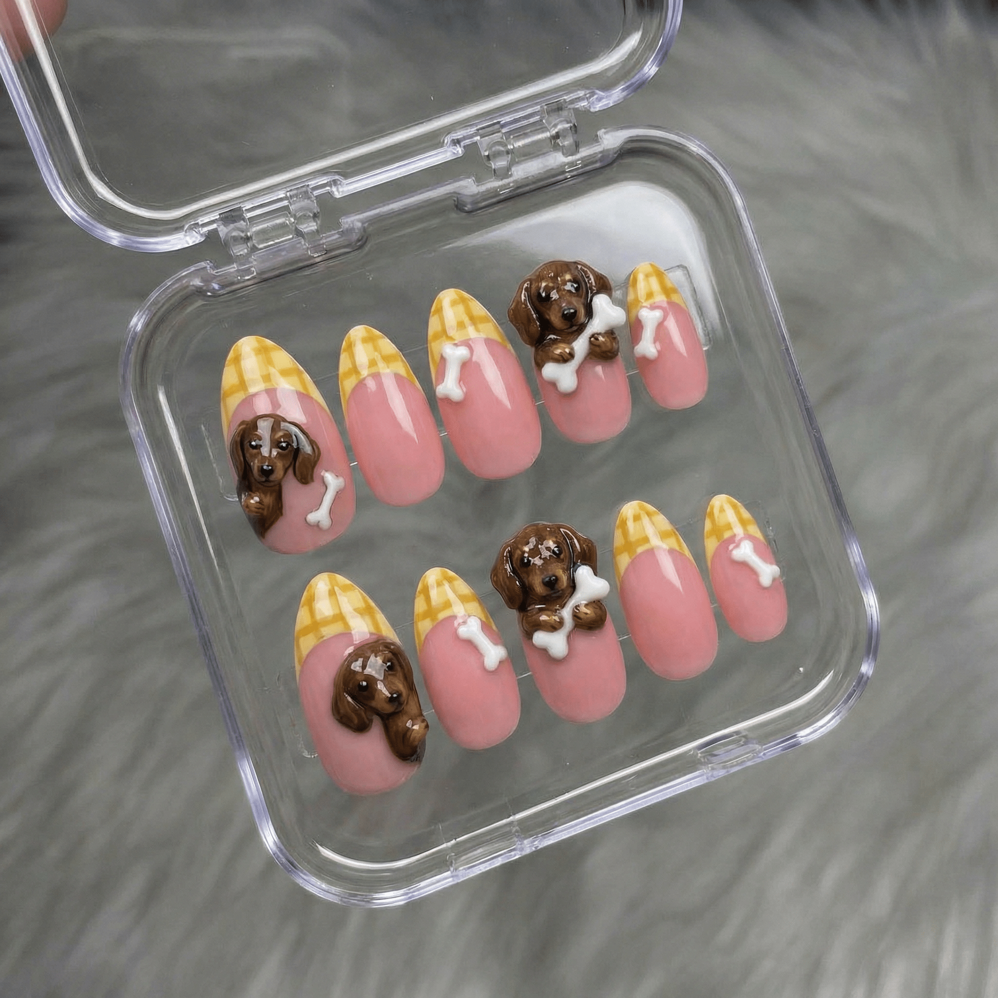 Doxie Treats press-on nails worn on hand – almond shape by Handora