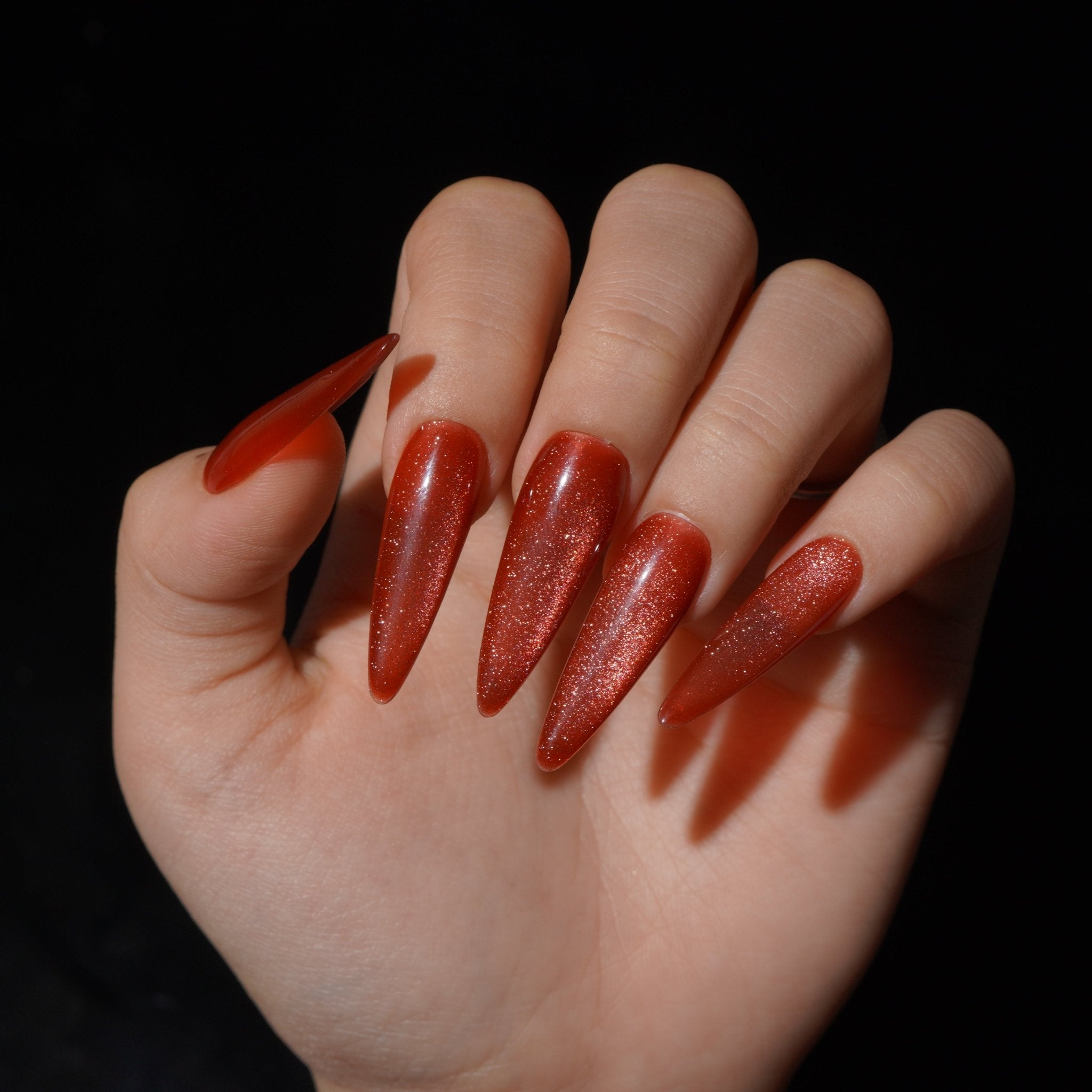 Emberglow press-on nails worn on hand – almond shape by Handora