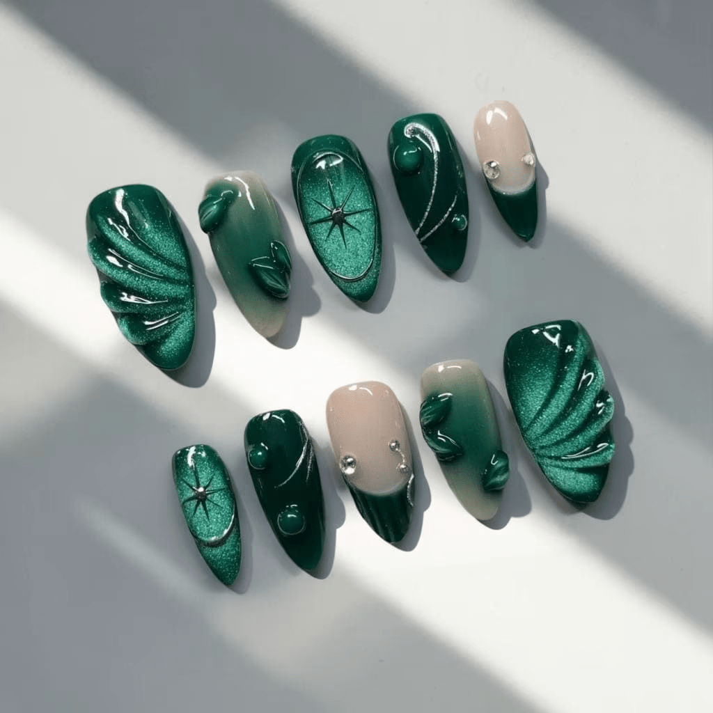 Emerald Elegance press-on nails worn on hand – almond shape by Handora