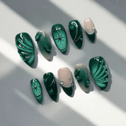 Emerald Elegance press-on nails worn on hand – almond shape by Handora