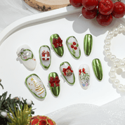 Emerald Noel press-on nails worn on hand – almond shape by Handora