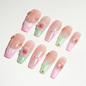Floral Bloom press-on nails worn on hand – coffin shape by Handora