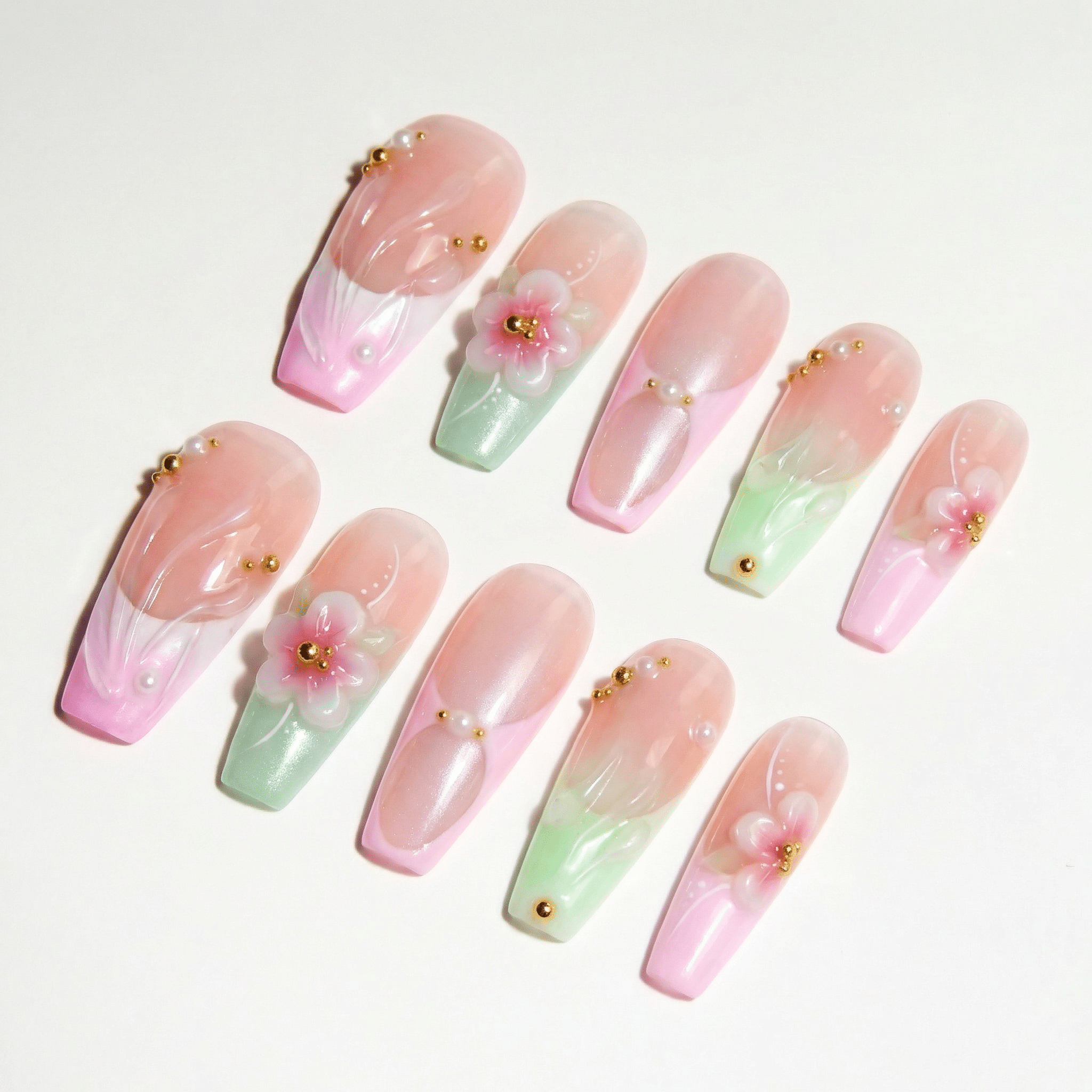 Floral Bloom press-on nails worn on hand – coffin shape by Handora