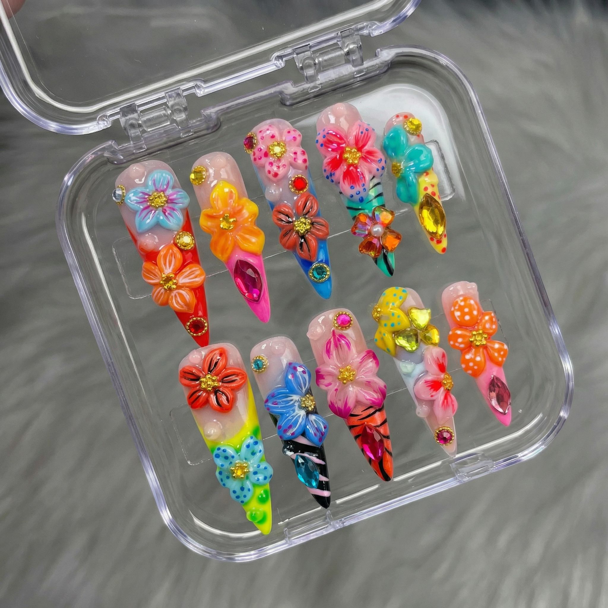 Floral Carnival press-on nails worn on hand – almond shape by Handora