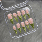 Floral Ceramic press-on nails worn on hand – stiletto shape by Handora