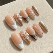 Floral Elegance press-on nails worn on hand – almond shape by Handora