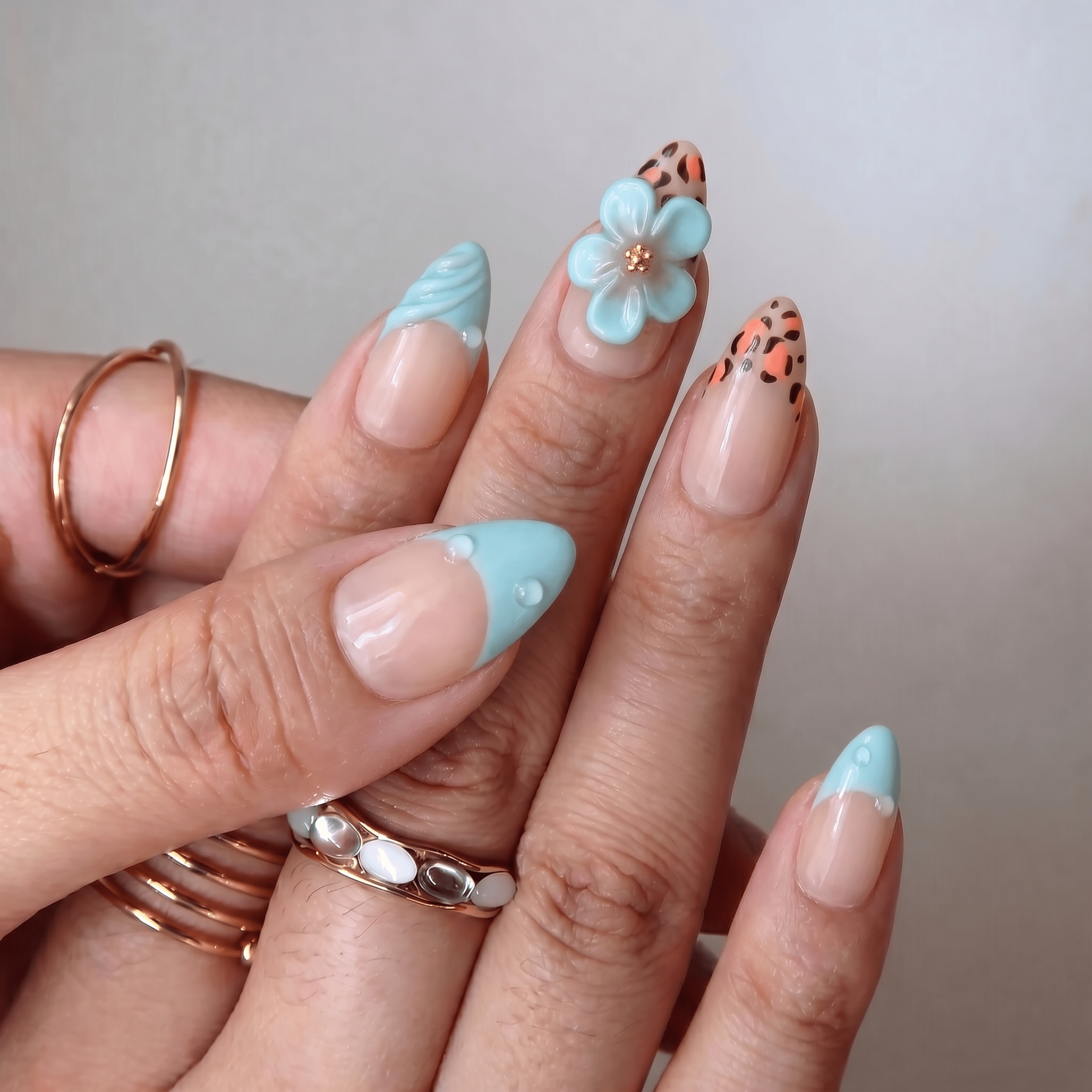 Floral Leopard press-on nails worn on hand – almond shape by Handora