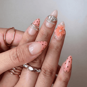 Floral Mocha press-on nails worn on hand – almond shape by Handora