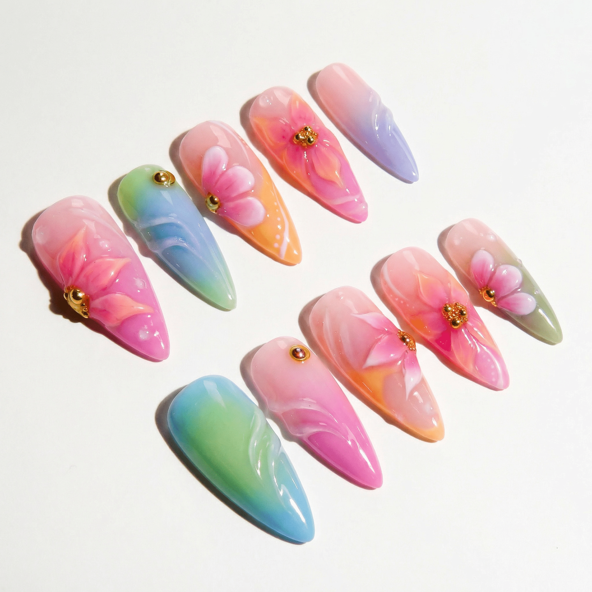 Floral Pastel press-on nails worn on hand – almond shape by Handora