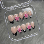 Floral Polka press-on nails worn on hand – almond shape by Handora