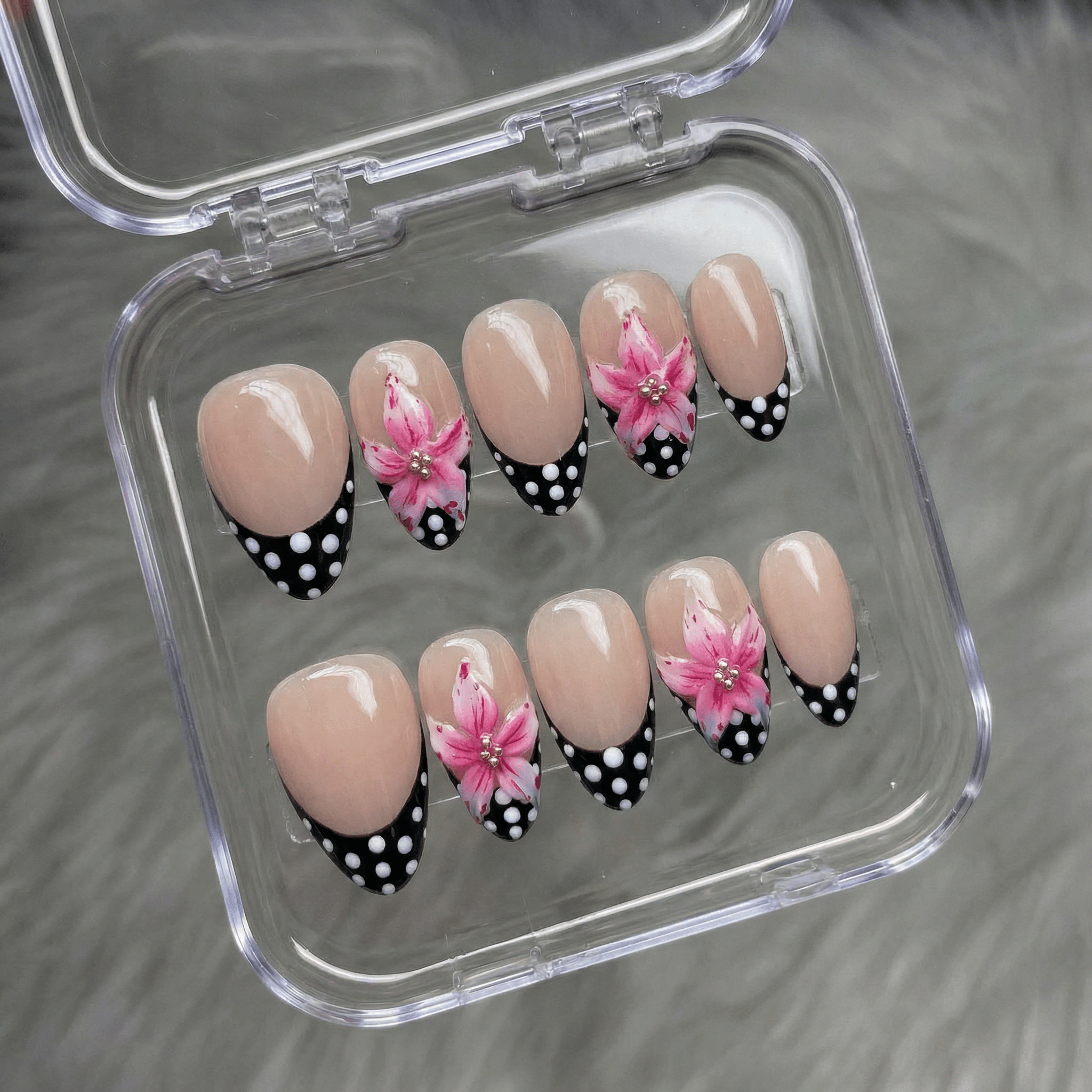 Floral Polka press-on nails worn on hand – almond shape by Handora
