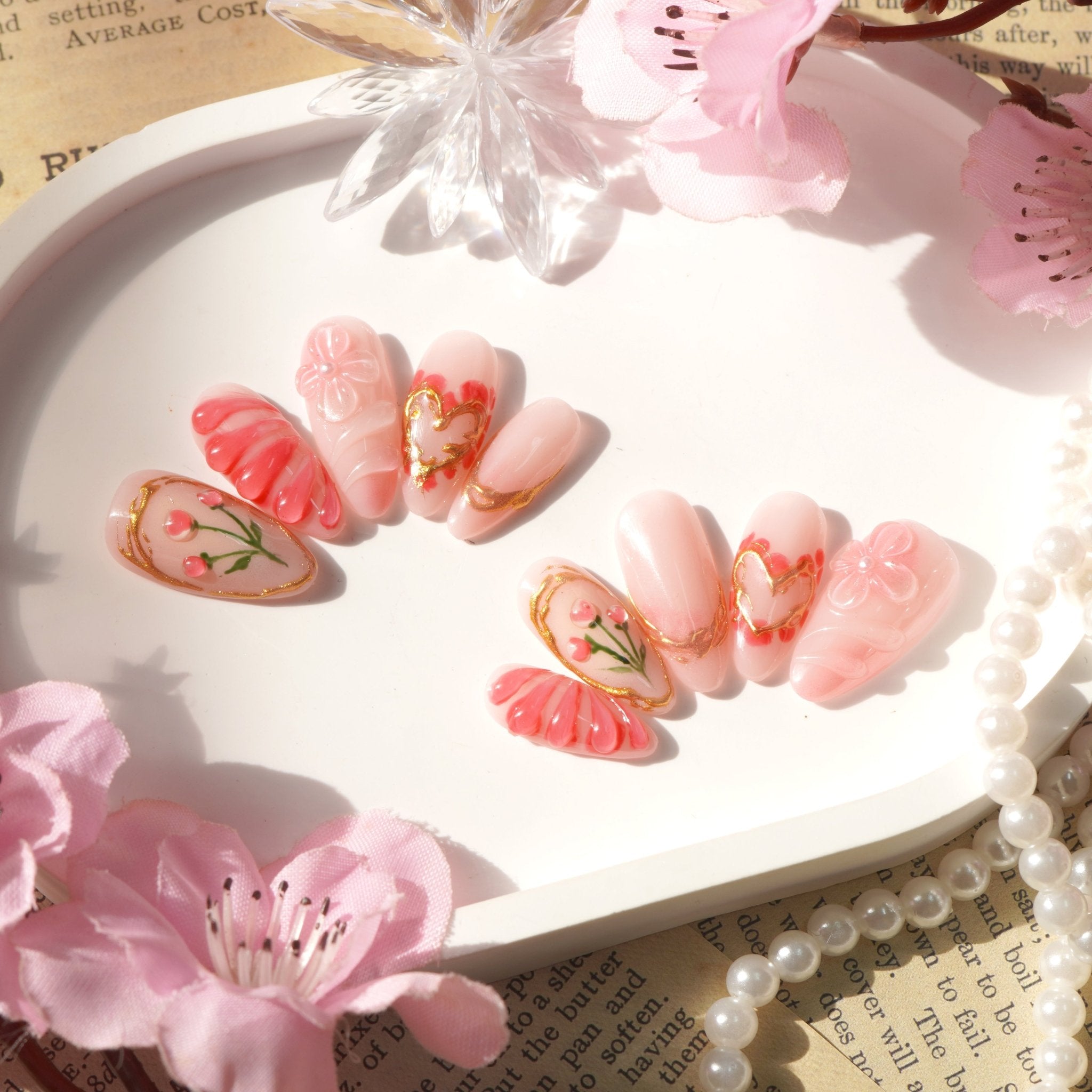Floral Romance press-on nails worn on hand – almond shape by Handora