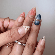 Floral Sapphire press-on nails worn on hand – almond shape by Handora