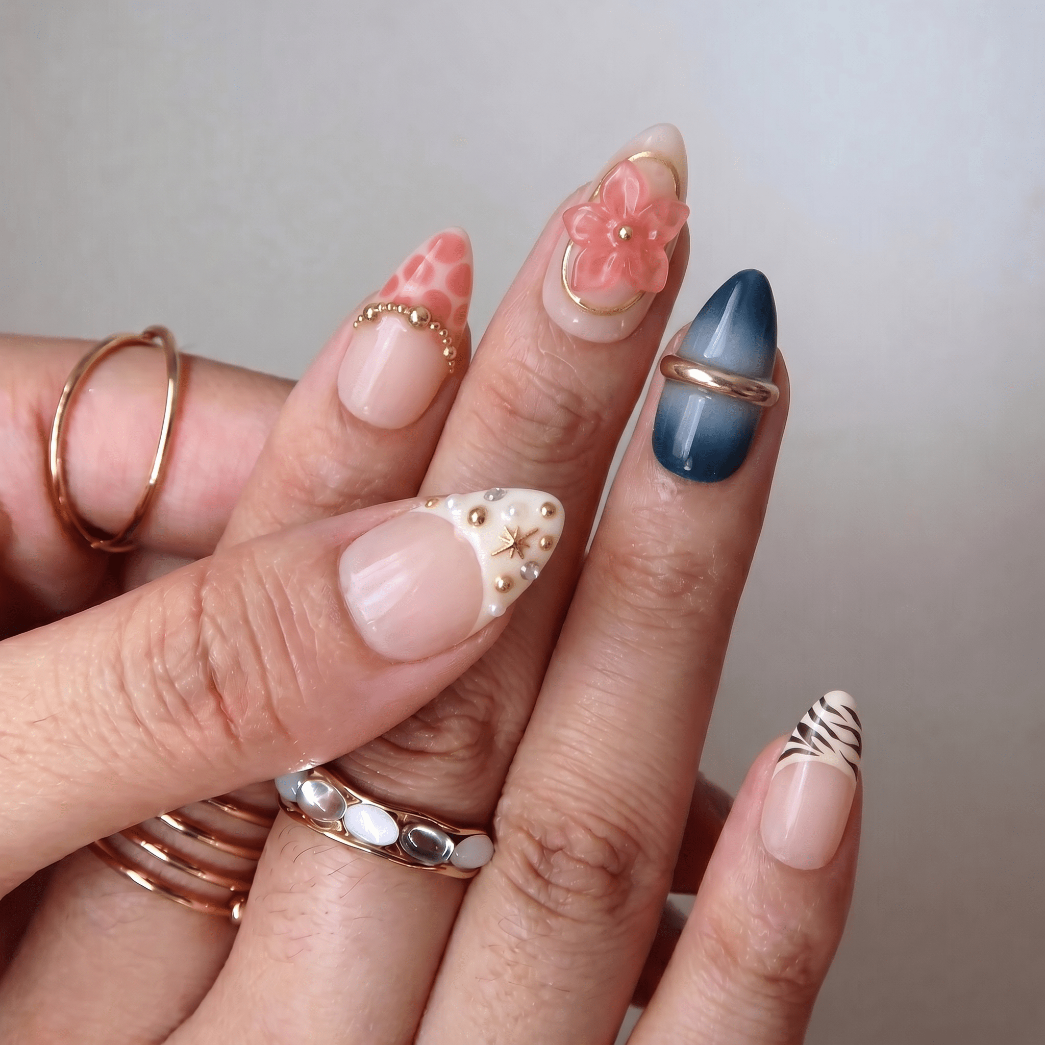 Floral Sapphire press-on nails worn on hand – almond shape by Handora