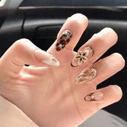 Floral Tortoise almond press-on nails – design close-up by Handora