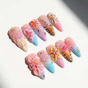 Floral Tropic press-on nails worn on hand – almond shape by Handora