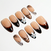 Cocoa Bloom press-on nails worn on hand – almond shape by Handora