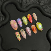 Fruit Carnival press-on nails worn on hand – almond shape by Handora