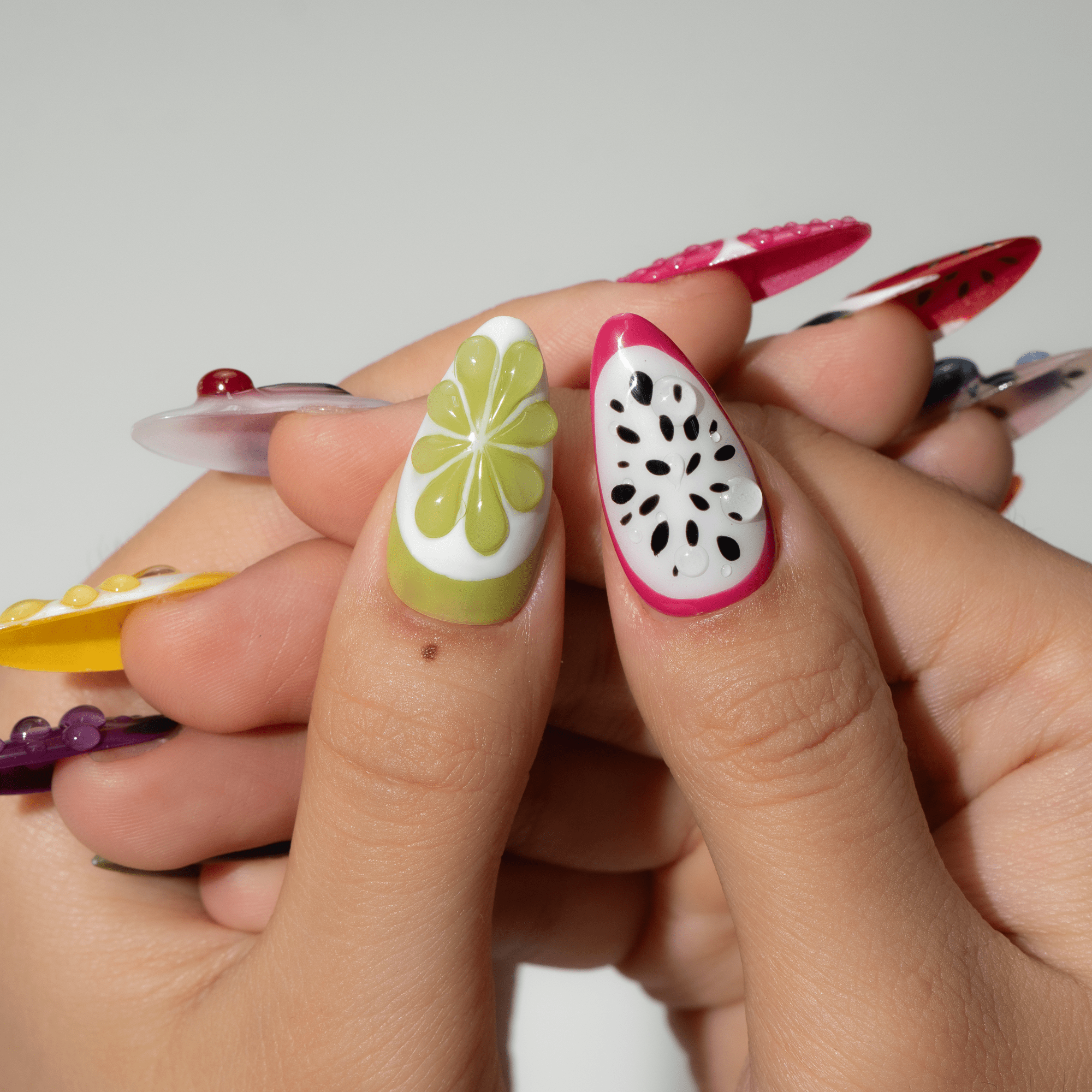 Fruity Party press-on nails worn on hand – almond shape by Handora