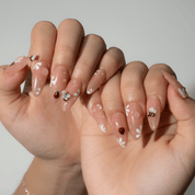 Garden Insects press-on nails worn on hand – almond shape by Handora