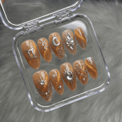 Gemini Vibe press-on nails worn on hand – almond shape by Handora