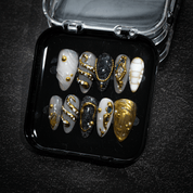 Gilded Baroque press-on nails worn on hand – almond shape by Handora
