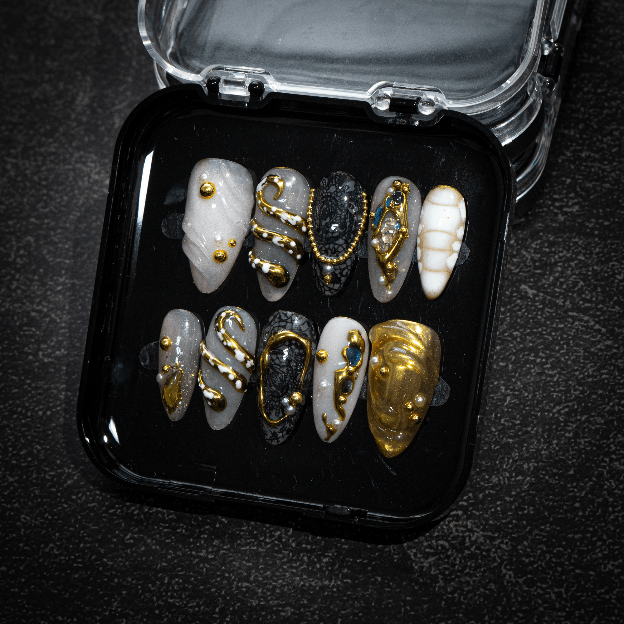 Gilded Baroque press-on nails worn on hand – almond shape by Handora
