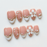 Gilded Bloom press-on nails worn on hand – almond shape by Handora