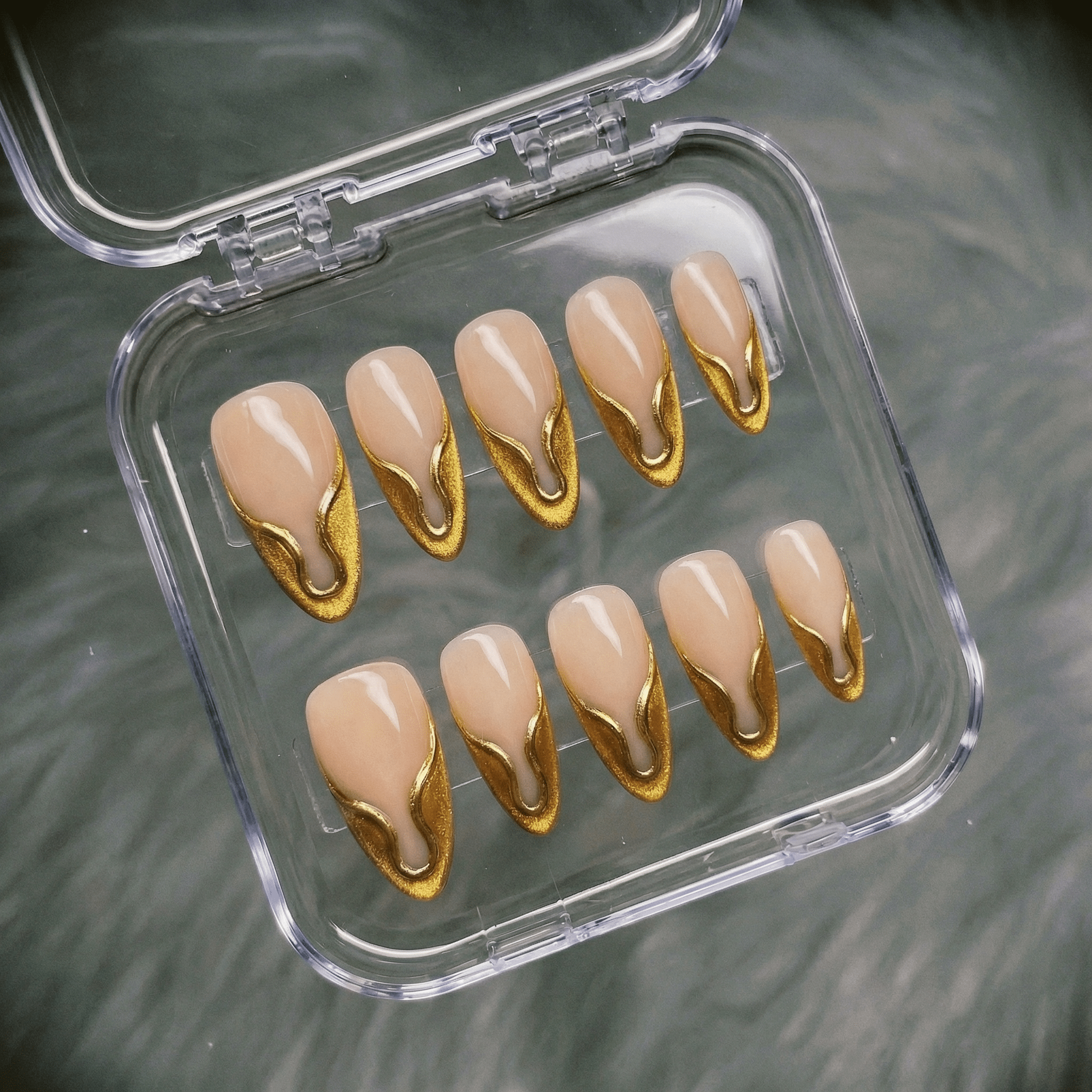 Gilded Onyx press-on nails worn on hand – almond shape by Handora