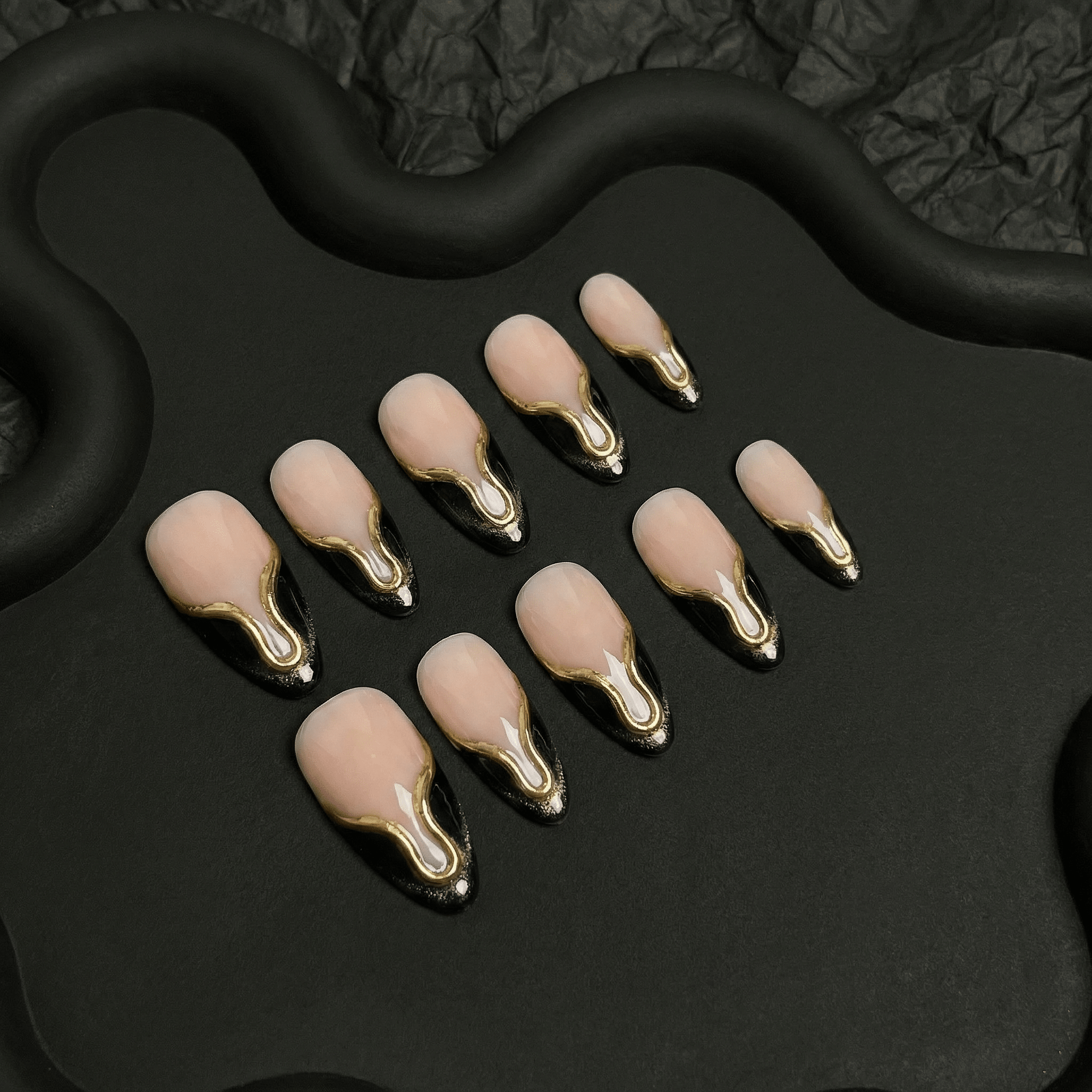 Gilded Onyx press-on nails worn on hand – almond shape by Handora