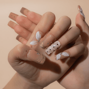 Gilded Petals press-on nails worn on hand – square shape by Handora