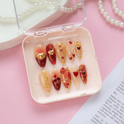 Gilded Romance press-on nails worn on hand – almond shape by Handora