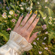 Golden Daffodil press-on nails worn on hand – almond shape by Handora
