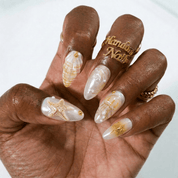 Golden Marine press-on nails worn on hand – almond shape by Handora