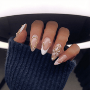 Golden Relief press-on nails worn on hand – almond shape by Handora