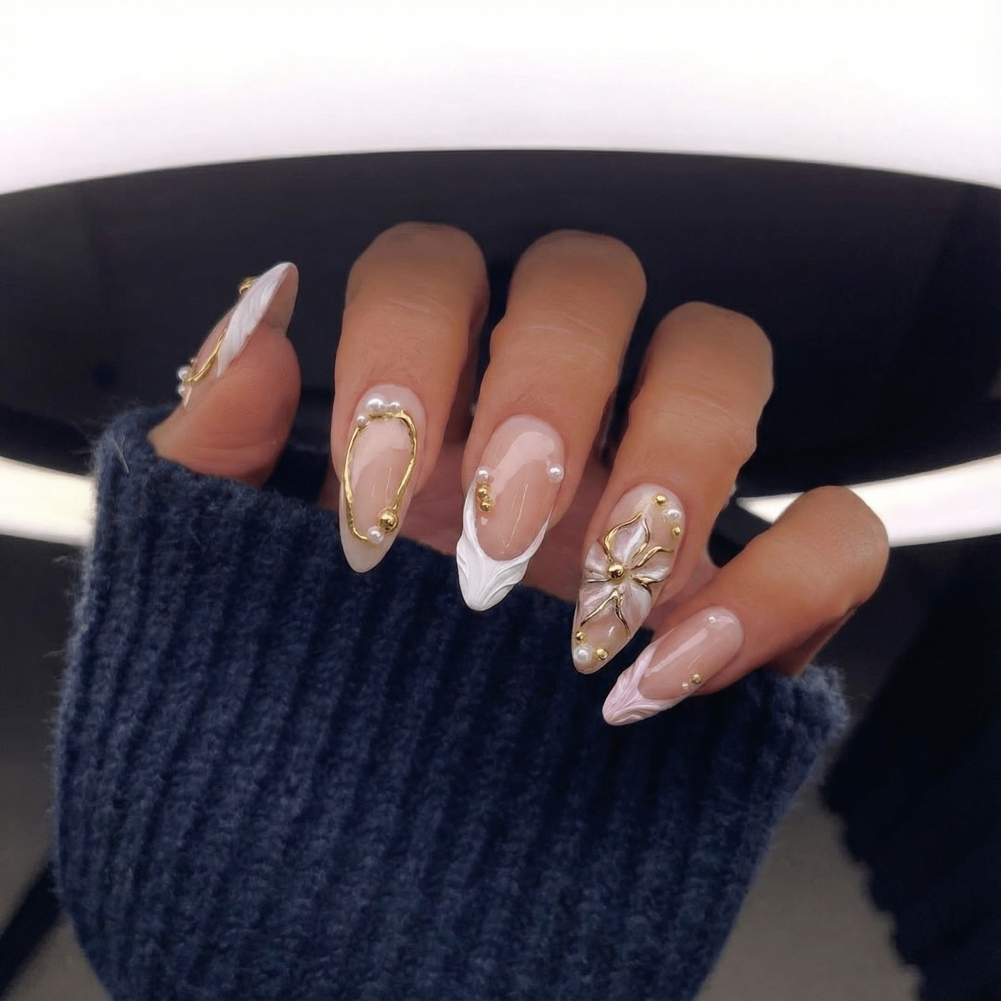 Golden Relief press-on nails worn on hand – almond shape by Handora