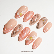 Golden Siren press-on nails worn on hand – almond shape by Handora