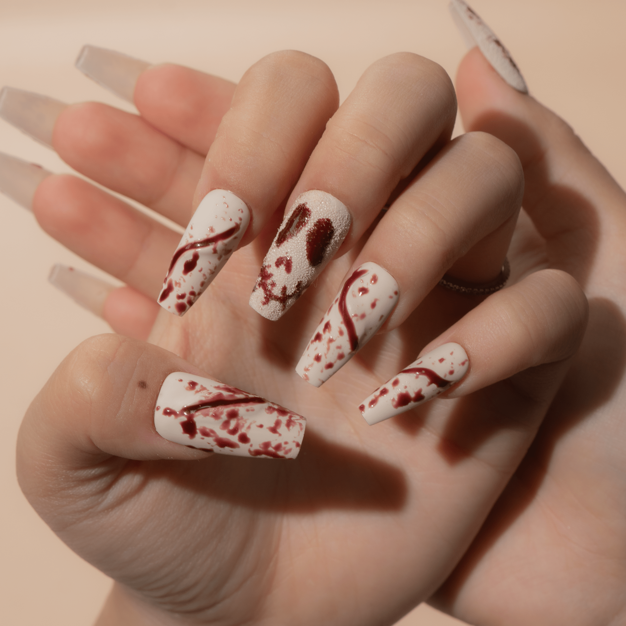 Gore Grunge press-on nails worn on hand – almond shape by Handora