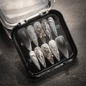 Gothic Chrome press-on nails worn on hand – almond shape by Handora